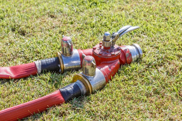 Firefighting equipment on grass — Stock Photo, Image