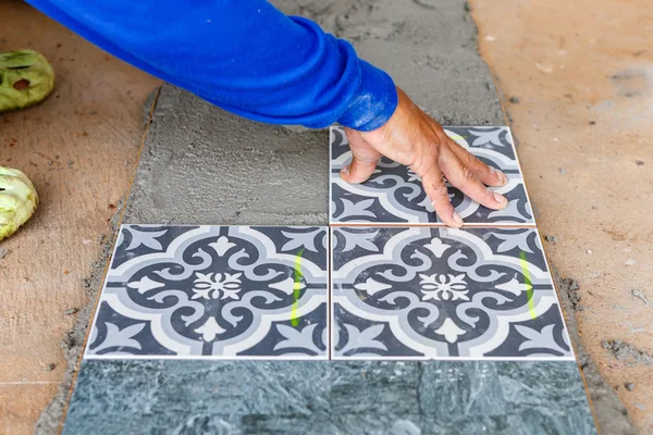 Installing floor tiles — Stock Photo, Image