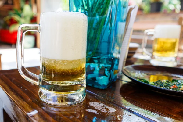 Beer with foam in restaurant — Stock Photo, Image