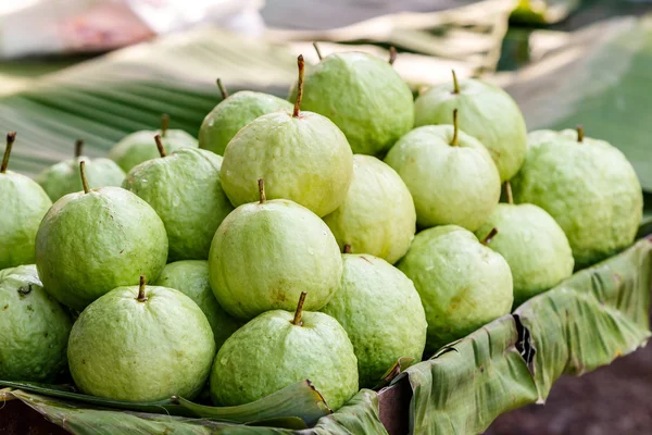 Green guava on banana leave — Stock Photo, Image