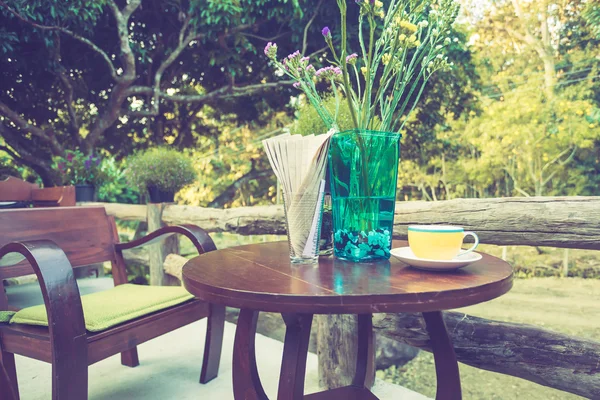 Koffiekopje op tafel in café met vintage kleurtoon — Stockfoto