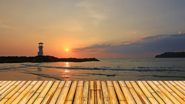 Lighthouse with sunset of thailand sea with  bamboor floor — Stock Photo, Image