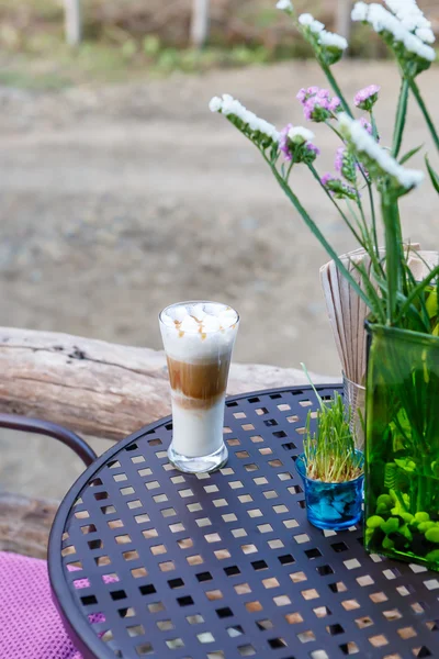 Caramel cappuccino coffee glass on table in cafe — Stock Photo, Image