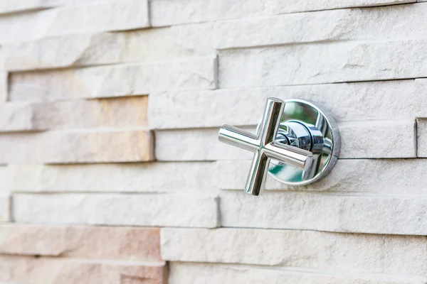 Faucet steel on stone wall — Stock Photo, Image