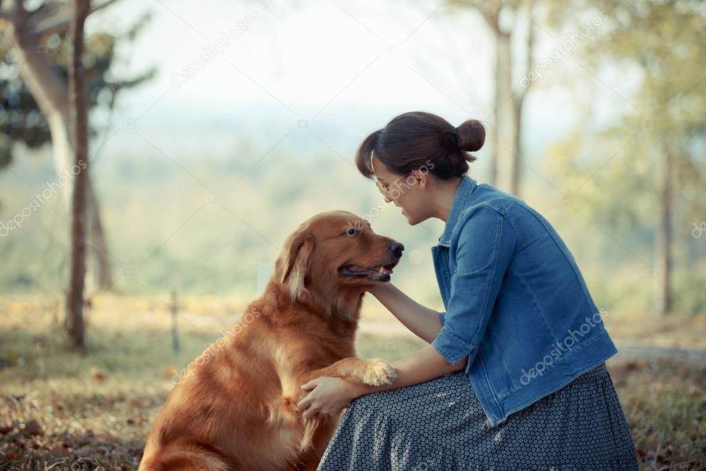 Beautiful woman with a cute golden retriver dog