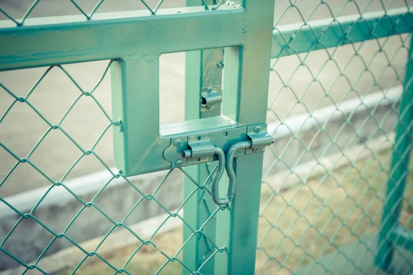 Green metal fence lock with pastel tone — Stock Photo, Image