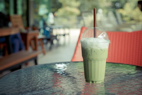 Ice green tea latte on table in cafe — Stock Photo, Image