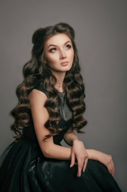 Curly girl looking up while sitting in the Studio
