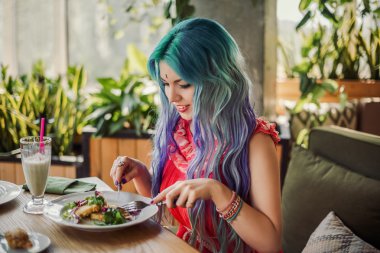 Bir kız bir vejeteryan kafede öğle yemeği yiyor