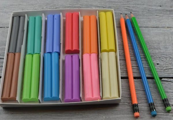 Plasticine Pencils Lie Wooden Background — Stock Photo, Image