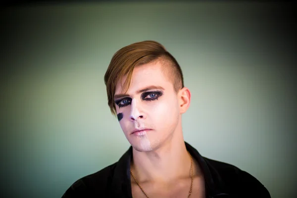 Composite image of serious young german fan with face paint against large football stadium — Stock Photo, Image