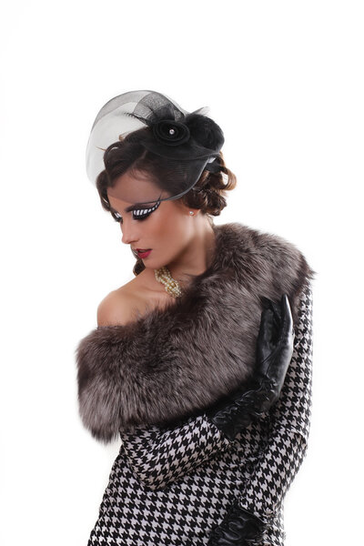 Fashion photo of pretty young curly woman with big blue beautiful eyes wearing a retro style in pink suite earrings, posing at studio