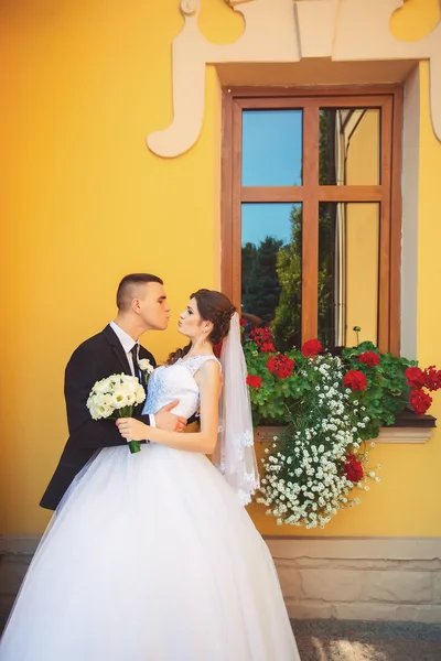 Beauty / Fashion / Hairstyle / Makeup photo shoot / Wedding. Wedding couple with bouquet outdoors. emotional portrait. insyagram toning effect