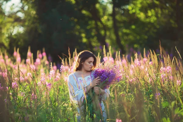 Beautiful young woman, holding lavender in a field on sunset. So — Stock Photo, Image