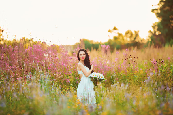Young beautiful girl in the field
