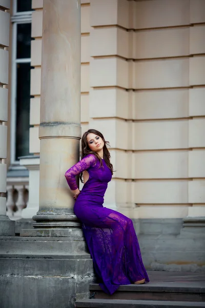 Pretty girl near old column with old building on background — Stock Photo, Image