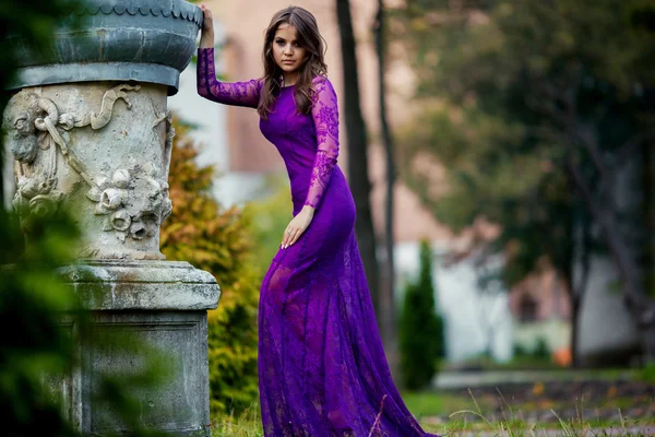 Menina bonita em um vestido de luxo caminha no parque de outono perto do th — Fotografia de Stock