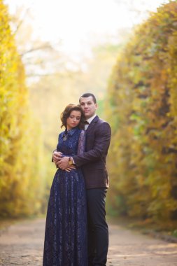 Beautiful married young couple standing with brides veil waving 