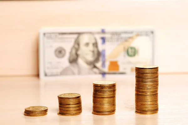 Coins on the table and blurred dollars back — Stock Photo, Image