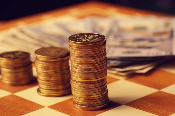 Una pila de monedas surtidas en la mesa de madera Fotos de stock