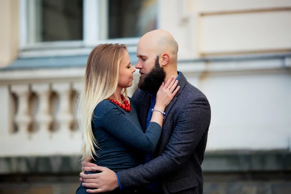 One beautiful stylish tender couple of young woman and senior man with long black beard embracing close to each other outdoor in spring sunny day — Stock Photo, Image