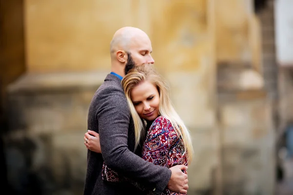 Cuplu tânăr îndrăgostit, îmbrăţişându-se pe stradă. Concentrare selectivă. tip chel cu barbă — Fotografie, imagine de stoc