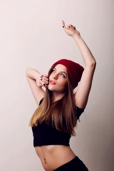 High joyful happy attractive Caucasian woman model sexy brunette hair shaking his head in the studio, wearing a black sleeveless shirt, isolated on a beige background — Stock Photo, Image