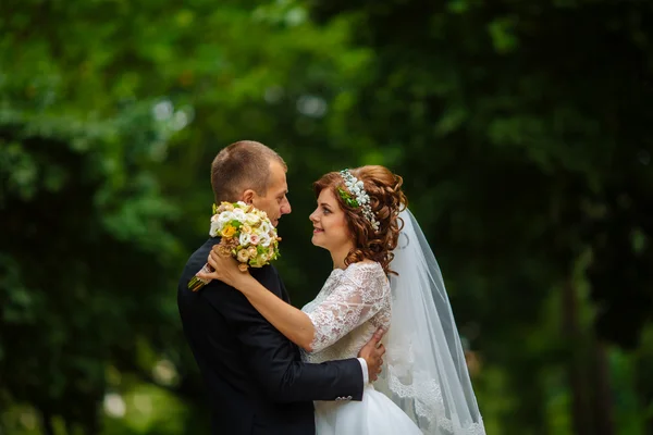 Coppia di nozze. Bellissimi sposi. Appena sposata. Chiudete. Buoni sposi che si abbracciano al loro matrimonio. Sposo e sposa in un parco. abito da sposa. Matrimonio nuziale, autunno — Foto Stock