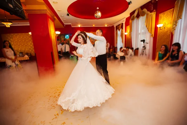 Just married couple dancing in front of their unrecognizable fri