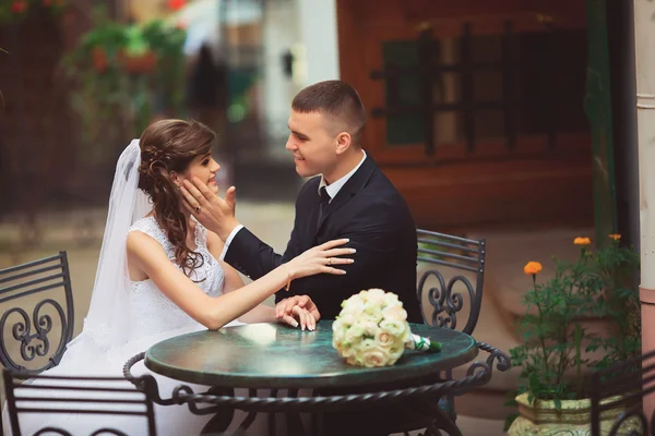 Bride sitting in cafe, looking at each other in love — Stock Photo, Image