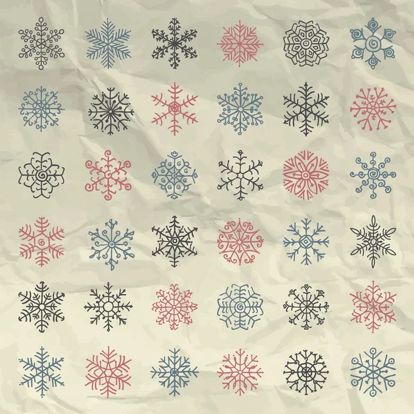 Διάνυσμα χειμώνα χιόνι νιφάδες Doodles σε τσαλακωμένο χαρτί — Διανυσματικό Αρχείο