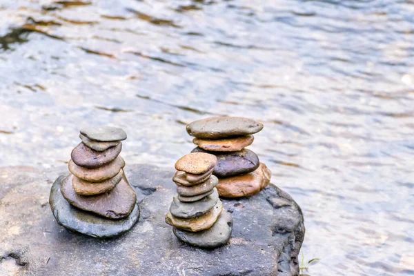 Balanced Zen rock stacks in a creek,View of a creek with stacked stones on a roc