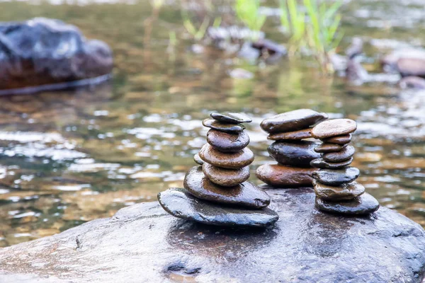 Balanced Zen rock stacks in a creek,View of a creek with stacked stones on a roc