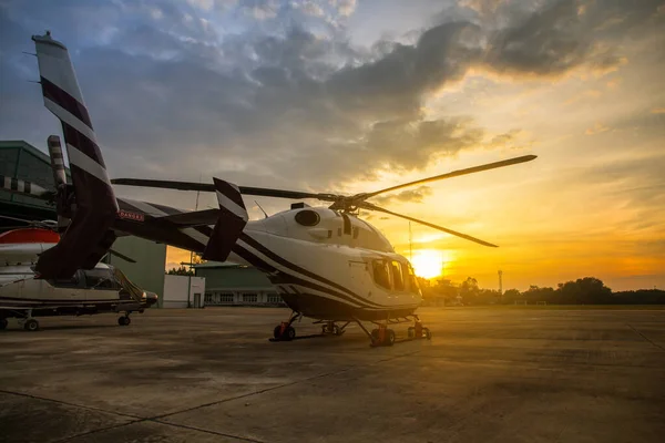 silhouette of helicopter in the parking lot or runway with sunrise background,twilight helicopter on the helipa