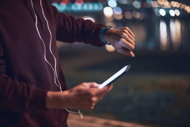 Şehir parkında kapüşonlu sweatshirt 'le antrenman yapan atletik sporcu..