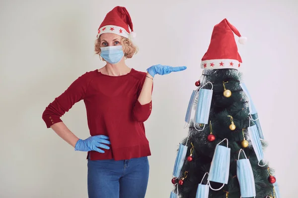 Mujer Decorando Árbol Navidad Con Máscaras Médicas Durante Pandemia Virus —  Fotos de Stock