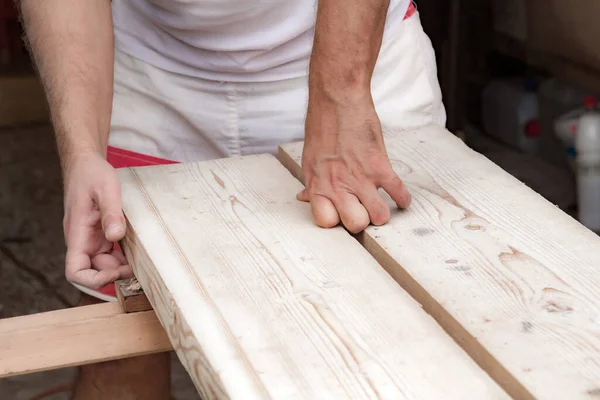 男木匠在车库里用木料干活 — 图库照片