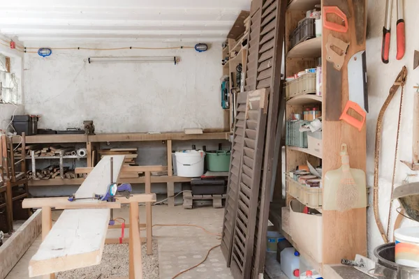 Various carpenter's tools and supplies in a garage.