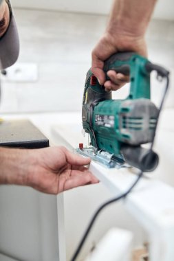 Tamirci mobilya montajı yapıyor ve tamir ediyor..