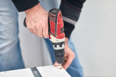 Tamirci mobilya montajı yapıyor ve tamir ediyor..