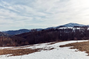 Uzak tepelerde karla kaplı bir dağın tepesinden bak..