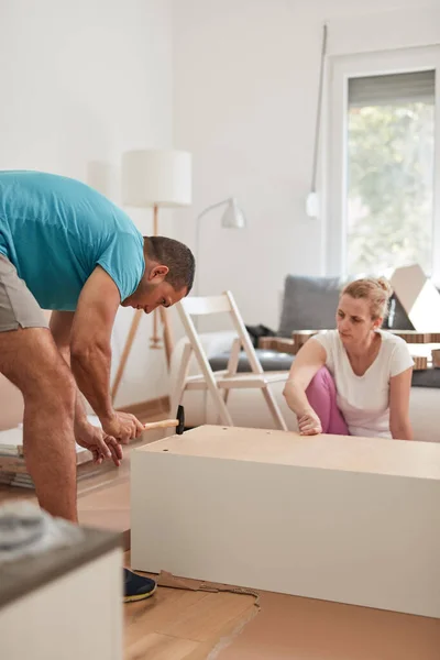 stock image Husband and wife assembling new furniture - renovation home concept.