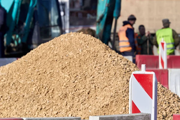 Heavy construction machines outdoors for public place reconstruction.