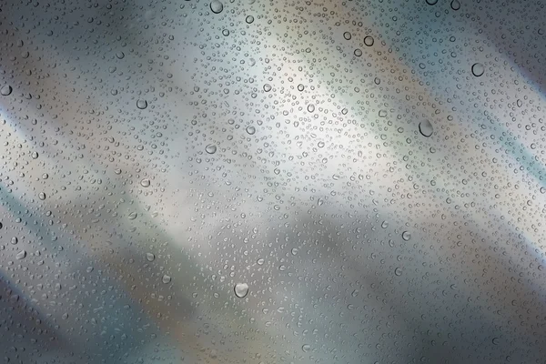 Gocce d'acqua su vetro e sfondo astratto con bokeh, defoc — Foto Stock