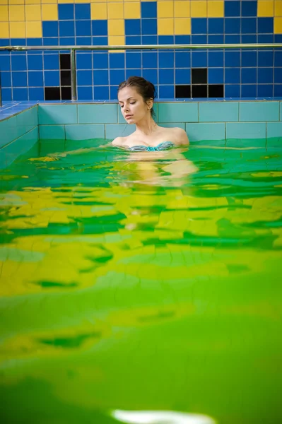 Donna in una piscina con acqua verde — Foto Stock