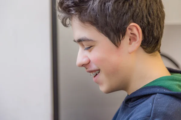 caucasian boy happy and smiling with braces on teeth