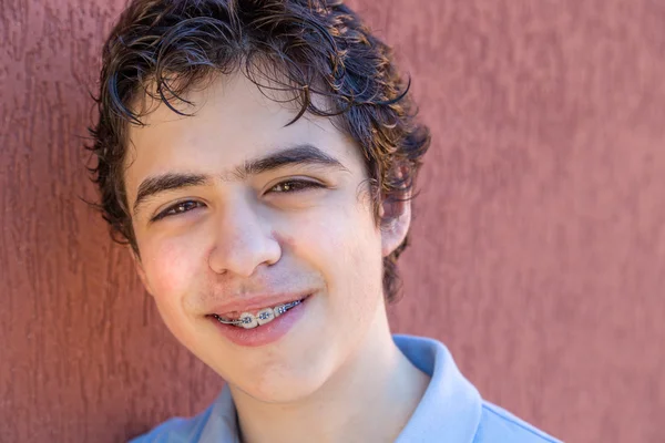 Boy Smiles Leaning Grunge Red Wall — Stock Photo, Image