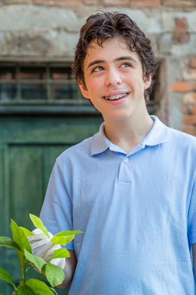 Teenager Braces Smiles While Taking Care Lemon Tree Holding Green — Stock Photo, Image