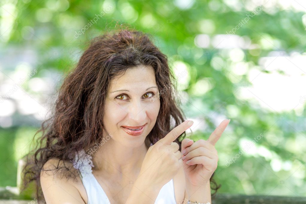 happy attractive woman pointing to the side with both hands