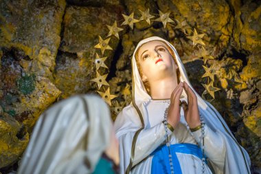 Blessed Virgin of Lourdes in cave clipart